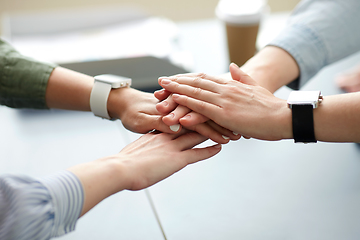 Image showing close up of business team stacking hands