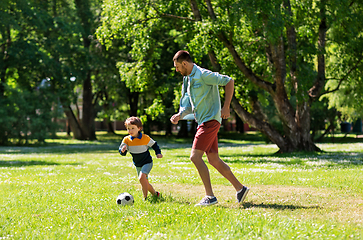 Image showing father with little son playing soccer at park