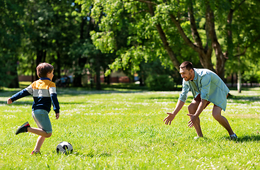 Image showing father with little son playing soccer at park