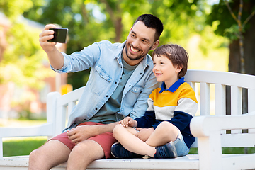 Image showing father and son taking selfie with phone at park