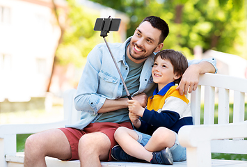 Image showing father and son taking selfie with phone at park