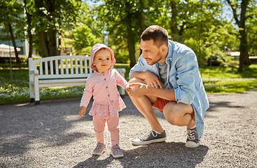 Image showing happy father with baby daughter at summer park