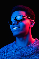 Image showing African-american man\'s portrait isolated on black studio background in multicolored neon light