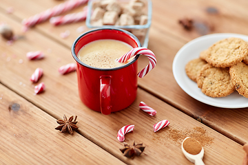 Image showing cup of eggnog with candy cane, cookies and sugar