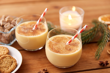 Image showing glasses of eggnog, oatmeal cookies and fir branch