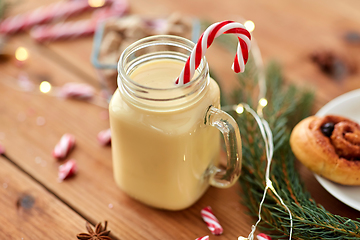 Image showing eggnog with candy cane in mug and cinnamon buns