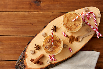 Image showing glasses of eggnog, ingredients and spices on wood