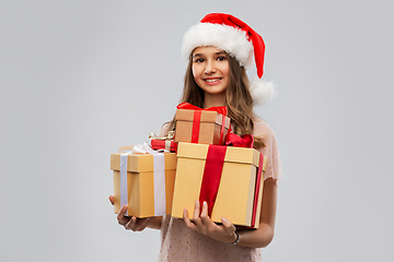 Image showing teenage girl in santa hat with christmas gift