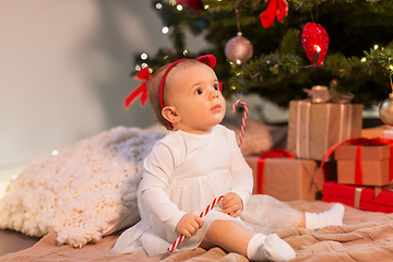 Image showing baby girl at christmas tree with gifts at home