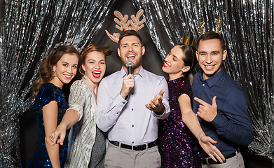 Image showing friends with microphone singing at christmas party