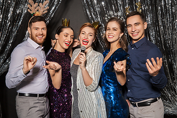 Image showing friends with microphone singing at christmas party