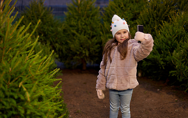 Image showing little girl taking selfie at christmas tree market