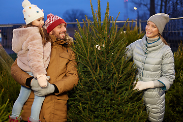 Image showing happy family choosing christmas tree at market