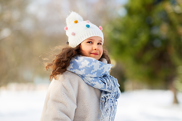 Image showing happy little girl in winter clothes outdoors