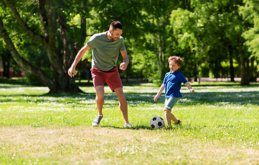 Image showing father with little son playing soccer at park