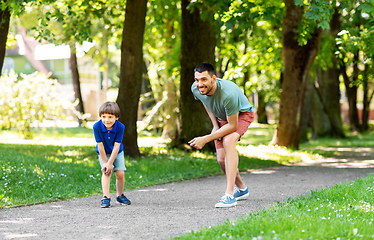 Image showing happy father and son compete in running at park