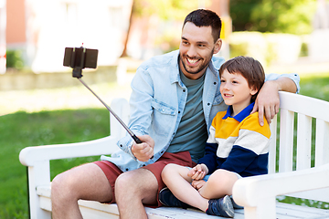 Image showing father and son taking selfie with phone at park