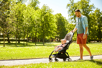 Image showing happy father with child in stroller at summer park