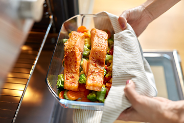 Image showing woman cooking food in oven at home kitchen