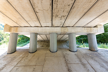 Image showing Close-up of bridge piers, concreted slope under the bridge