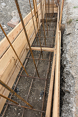 Image showing Reinforcement of the strip foundation, lower layer of reinforcement, unfinished formwork