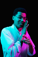 Image showing African-american man\'s portrait isolated on black studio background in multicolored neon light