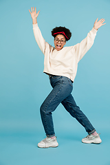 Image showing African-american woman\'s portrait isolated on blue studio background with copyspace