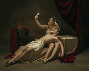 Image showing Modern remake of classical artwork with modern tech theme - young medieval couple on dark background