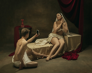 Image showing Modern remake of classical artwork with modern tech theme - young medieval couple on dark background