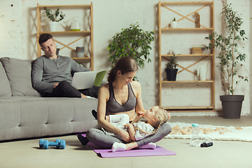 Image showing Young woman exercising fitness, aerobic, yoga at home, sporty lifestyle. Getting active during lockdown, quarantine. Home gym.