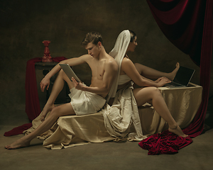 Image showing Modern remake of classical artwork with modern tech theme - young medieval couple on dark background