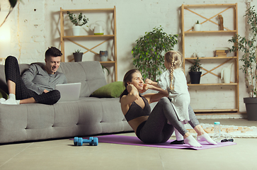 Image showing Young woman exercising fitness, aerobic, yoga at home, sporty lifestyle. Getting active during lockdown, quarantine. Home gym.