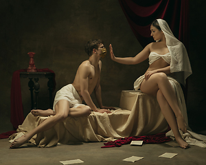 Image showing Modern remake of classical artwork with coronavirus theme - young medieval couple on dark background