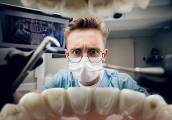 Image showing Doctor looking into the mouth, checking, examining teeth