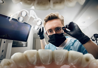 Image showing Doctor looking into the mouth, checking, examining teeth