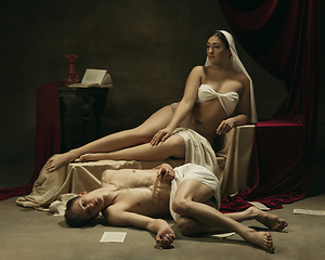 Image showing Modern remake of classical artwork - young medieval couple on dark background, comparison of eras concept