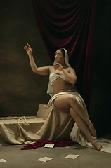 Image showing Modern remake of classical artwork - young medieval woman on dark background, comparison of eras concept