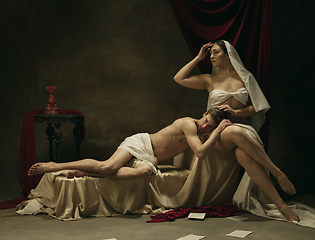 Image showing Modern remake of classical artwork - young medieval couple on dark background, comparison of eras concept