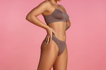 Image showing Beautiful body of young african-american woman isolated on pink studio background