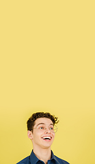 Image showing Caucasian man\'s portrait isolated on yellow studio background with copyspace