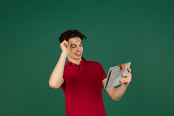 Image showing Caucasian man\'s portrait isolated on green studio background with copyspace