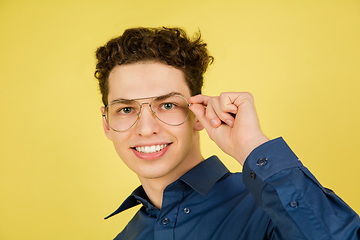 Image showing Caucasian man\'s portrait isolated on yellow studio background with copyspace