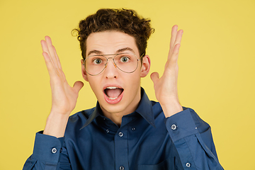 Image showing Caucasian man\'s portrait isolated on yellow studio background with copyspace