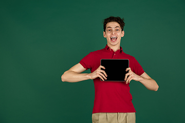 Image showing Caucasian man\'s portrait isolated on green studio background with copyspace