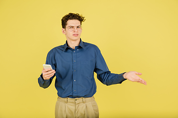 Image showing Caucasian man\'s portrait isolated on yellow studio background with copyspace