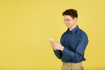 Image showing Caucasian man\'s portrait isolated on yellow studio background with copyspace