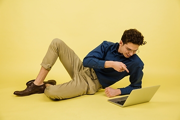 Image showing Caucasian man\'s portrait isolated on yellow studio background with copyspace