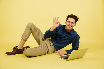 Image showing Caucasian man\'s portrait isolated on yellow studio background with copyspace