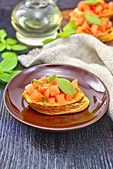 Image showing Bruschetta with tomato and basil in plate on board