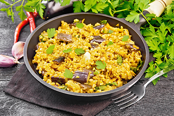 Image showing Bulgur with eggplant in pan on dark board